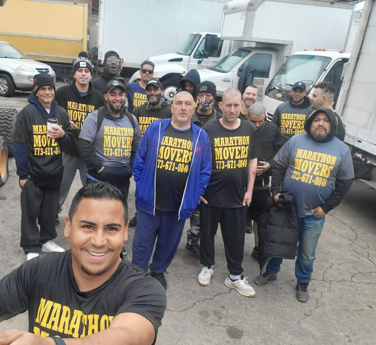 The Chicago Marathon Movers crew in matching shirts in front of their trucks