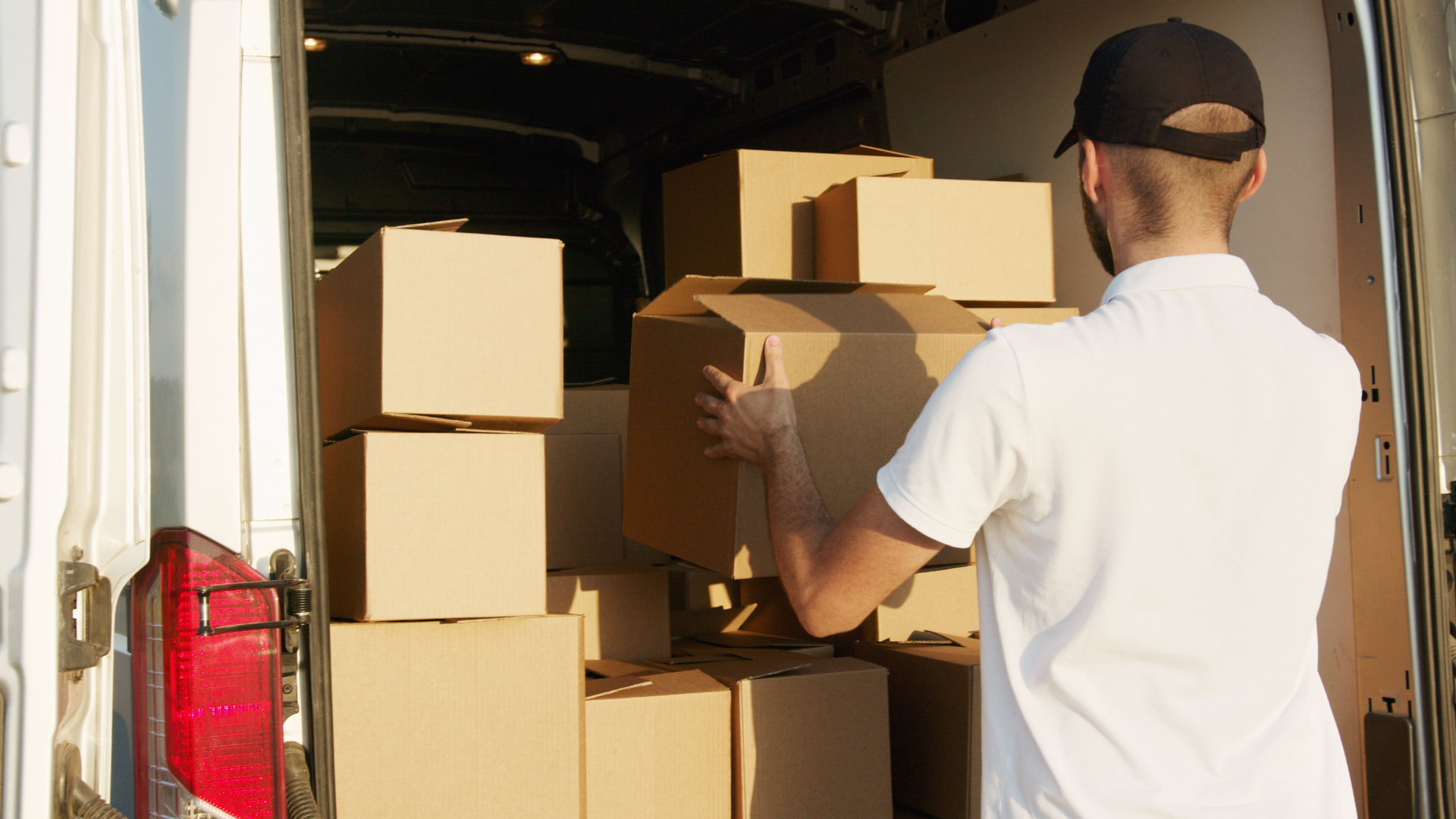 Professional mover loading boxes into a moving van